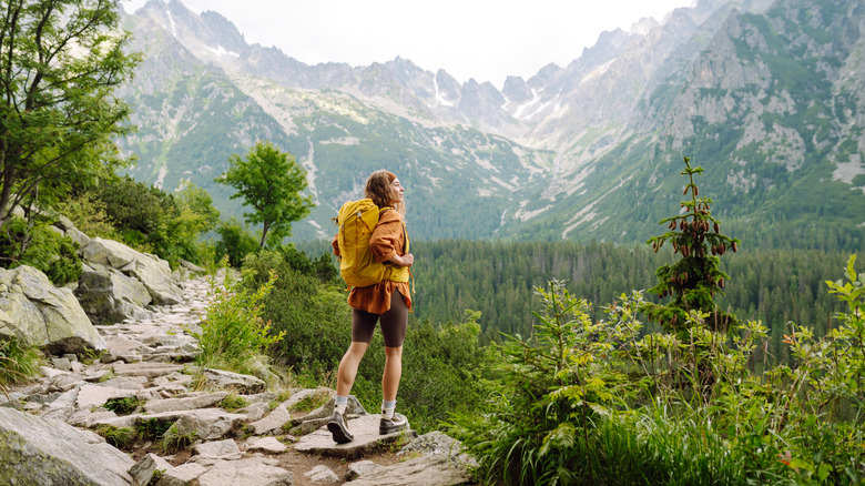 female backpacker enjoying mountain views