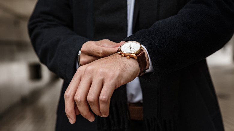 Man adjusting his luxury watch to go with his outfit