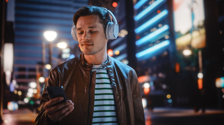 man listening to music in city