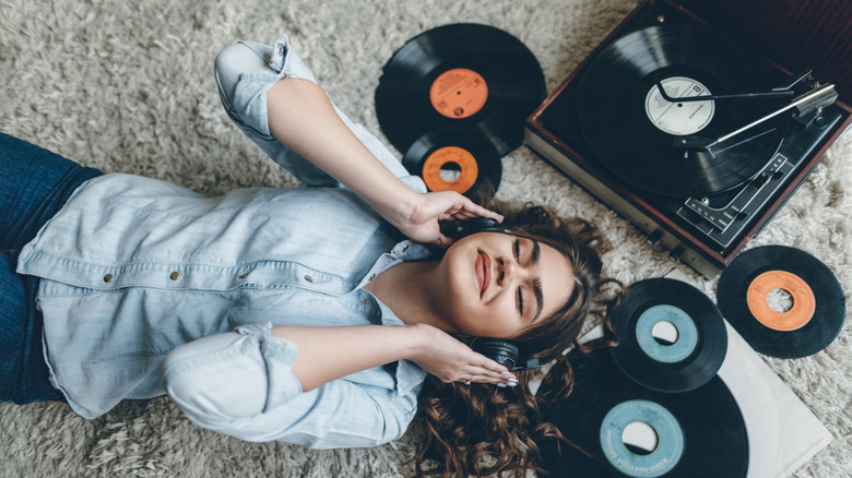 woman listening to vinyl records