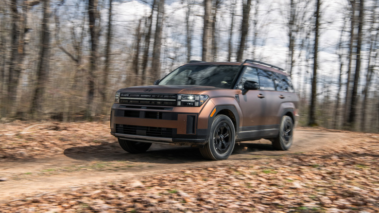 2024 Hyundai Santa Fe driving in the woods