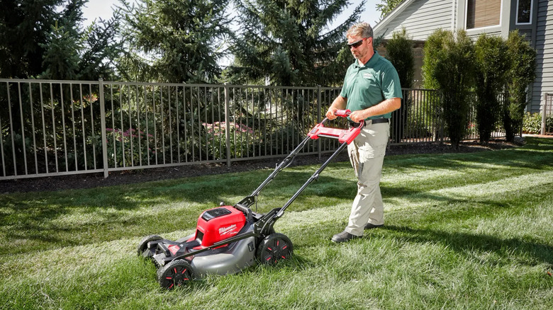 Man mowing lawn with Milwaukee mower