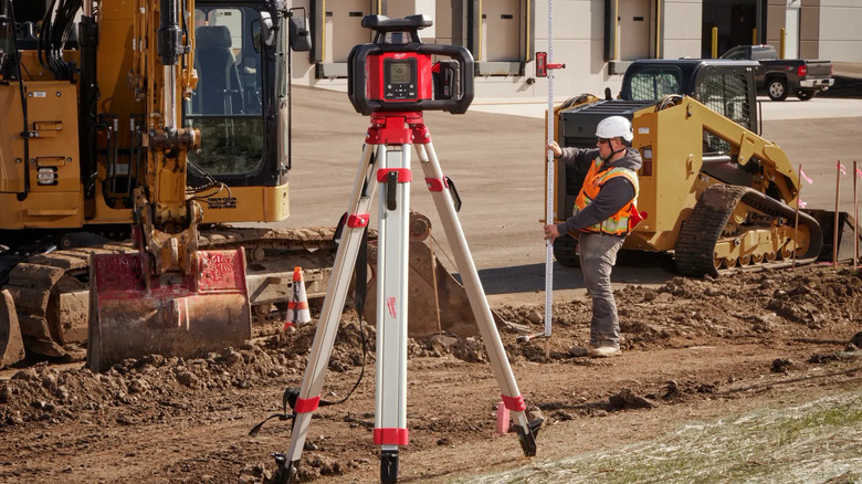 Milwaukee laser level on tripod at construction site