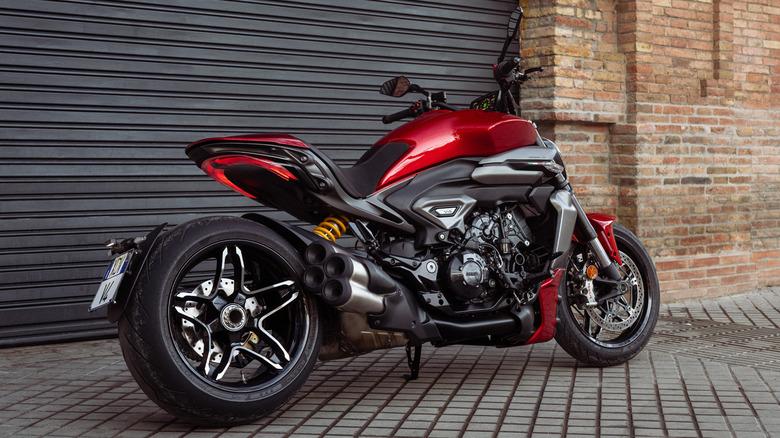 Red Ducati XDiavel V4 parked in front of a building