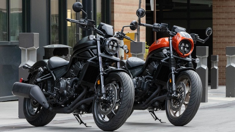 Black and orange Honda Rebel 1100s parked side by side