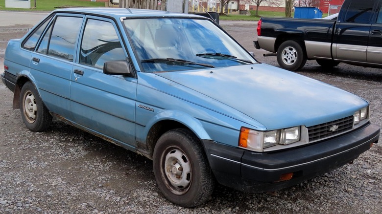 Blue 1985 - 1986 Chevrolet Nova parked on gravel