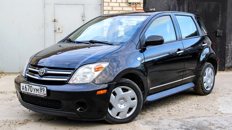 Black Scion xA parked