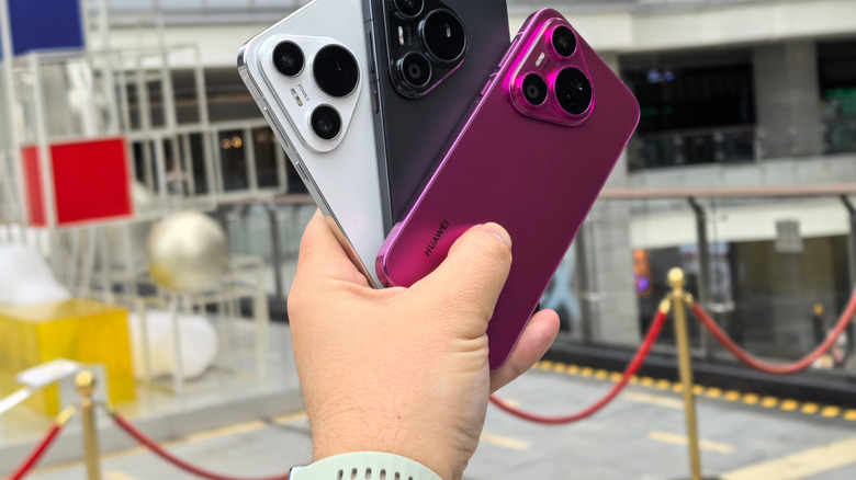 Three different colors of the Huawei Pura 70 Ultra held in the hand