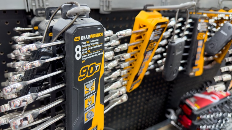 Display of GearWrench branded wrenches hanging on a wall