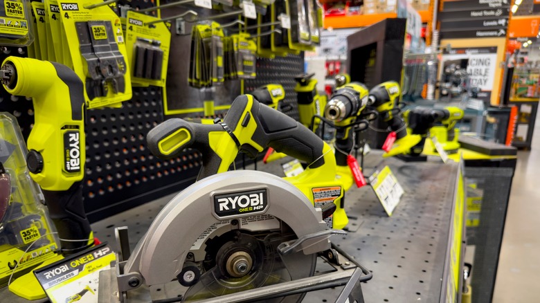 Store display of various neon green Ryobi brand tools