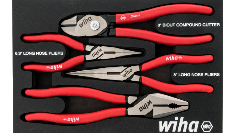 Set of Wiha branded pliers with red handles facing opposite directions