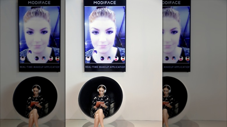 Woman using ModiFace app on a tablet