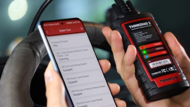 ThinkDiag+ app and OBD scanner in hands