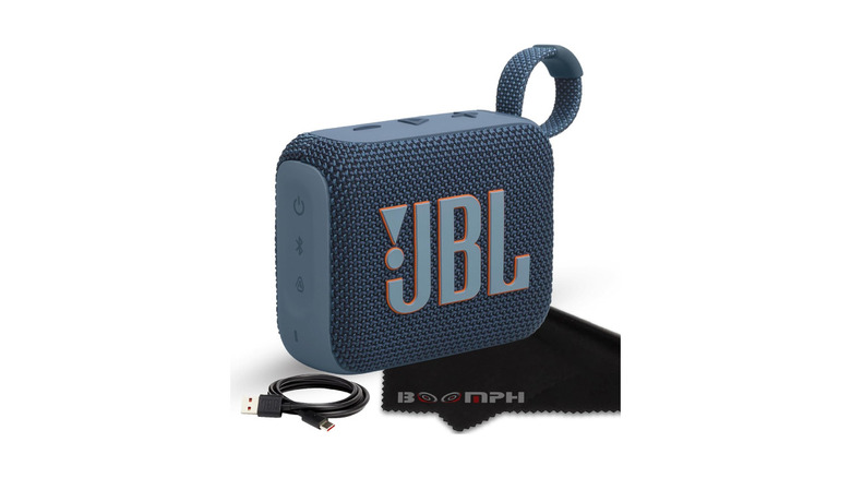 JBL Go 4 rugged speaker with a charging cable and cleaning cloth