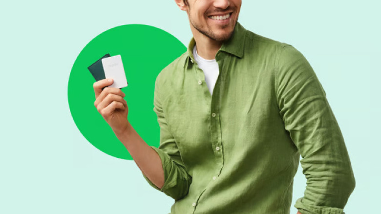 person holding a Chipolo Card Point and wallet