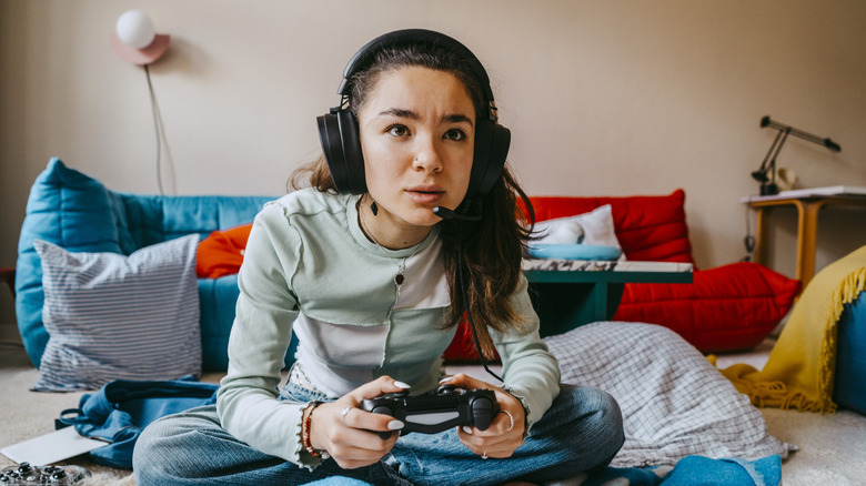 Gamer wearing headset on floor