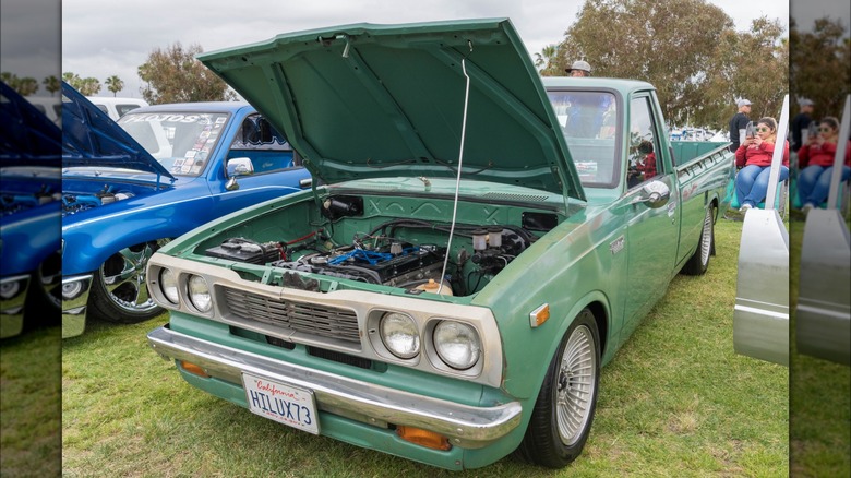 Green Toyota Hilux 1973 with the hood up