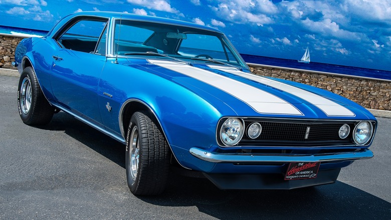 A blue 1967 Camaro with white racing stripes