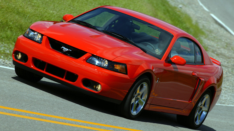 The Ford Mustang SVT "Terminator" Cobra in red driving, front 3/4 view