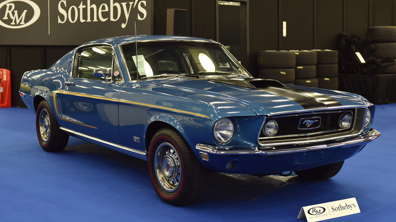 A pristine Ford Mustang 428 Cobra Jet in blue, front 3/4 view