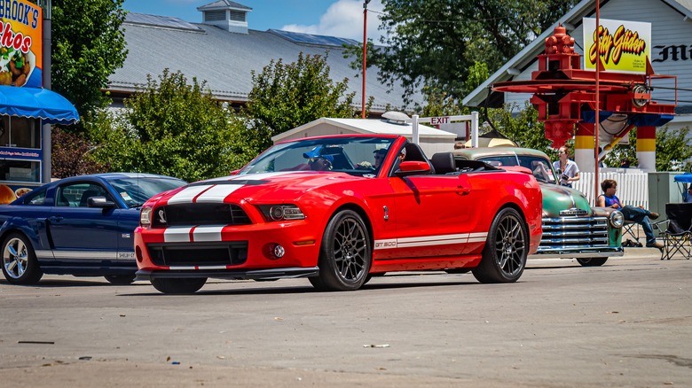 The 2013 Shelby GT500 convertible, red with white stripes, front 3/4 view