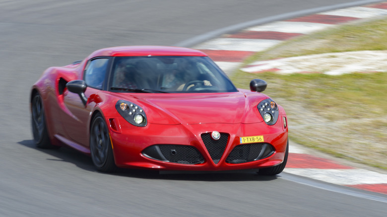 Red Alfa Romeo 4C coupe driving on track