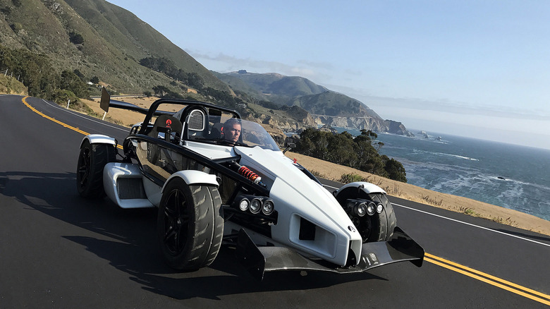 Ariel Atom 3S driving on a road near the sea