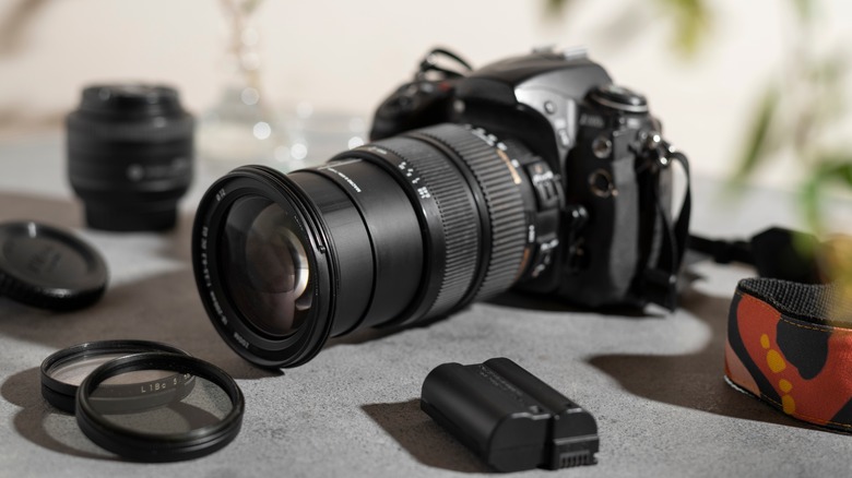 DESLR camera with lens and other photography equipment.