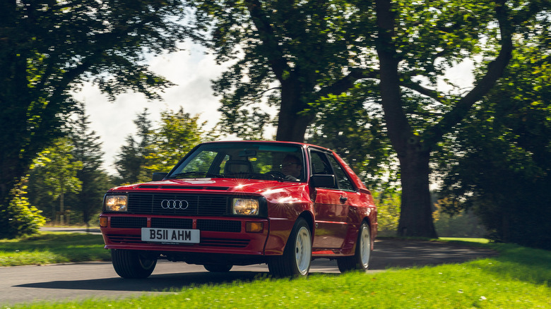 Red Audi Sport Quattro driving front 3/4