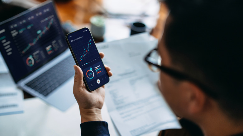 A man checking his investments on a mobile phone