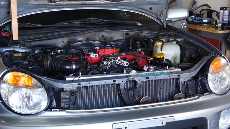 Subaru Impreza WRX with an open bonnet revealing EJ205 engine