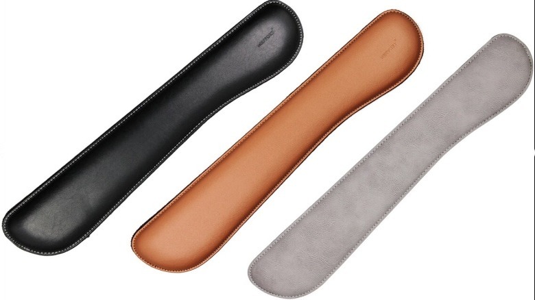 A series of identical leather wrist rests in black, tan, and gray