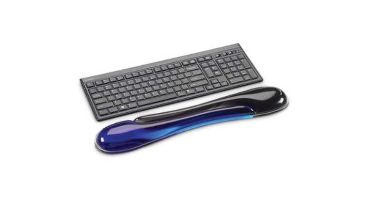 Shiny blue wrist support in front of a black keyboard