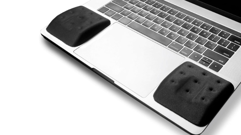 Two black wrist pads on either side of a laptop keyboard