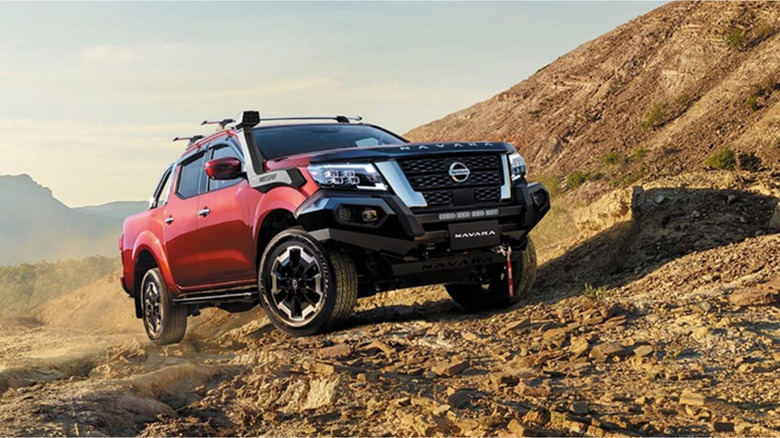 A Nissan Navara driving over rocky terrain