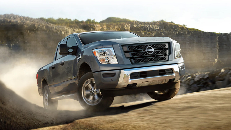 A Nissan Titan driving along a dirt path