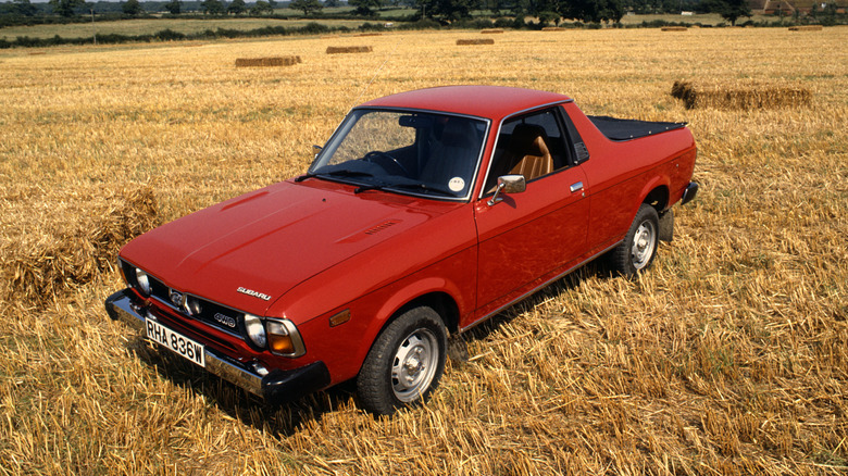 A red Subaru BRAT in a field, front 3/4 view