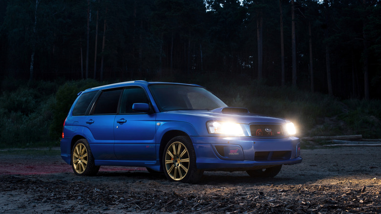 A blue Subaru Forester STI at dusk, front 3/4 view