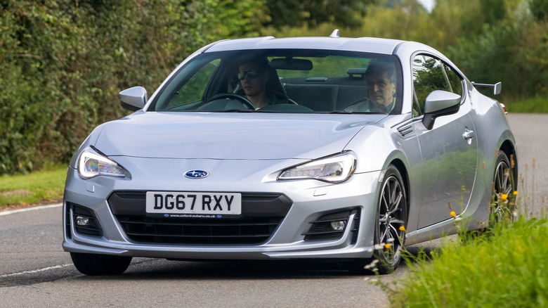 A silver Subaru BRZ cornering hard, front 3/4 view