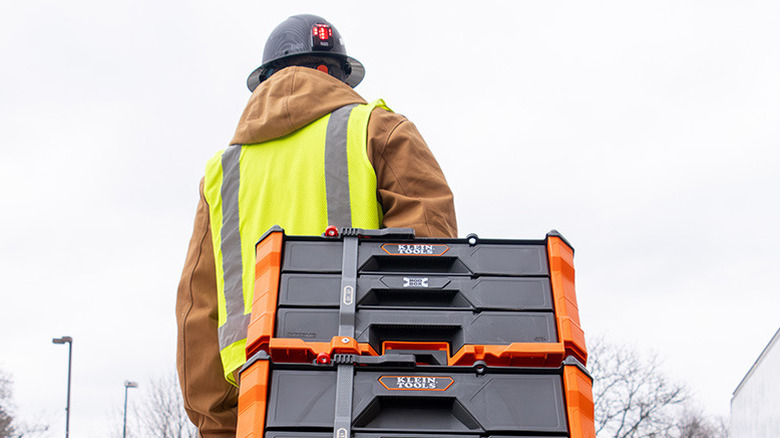 person pulling stacked tool boxes