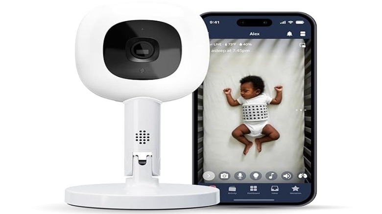 White camera on a short stand with a smartphone image of a sleeping baby