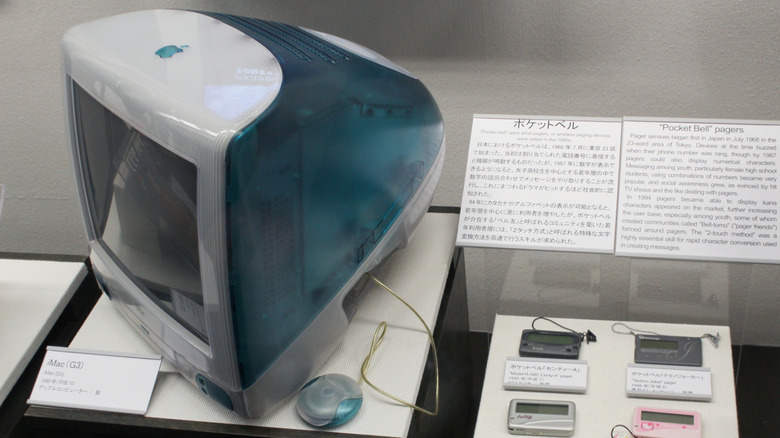 A teal blue iMac G3 on a table