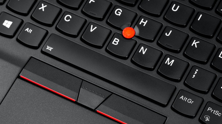 A Lenovo ThinkPad with its iconic red joystick mouse control