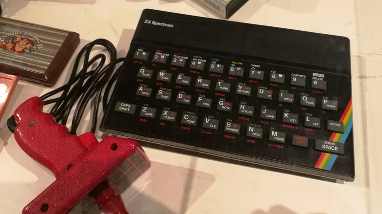 A ZX Spectrum with a joystick attachment on a table