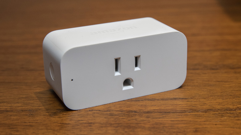 An Amazon smart plug on a wooden table