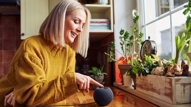 a woman using a smart speaker