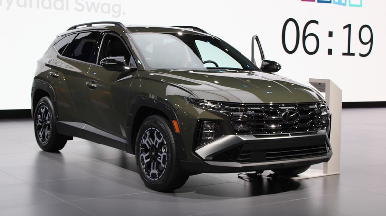 A green Hyundai Tucson on a showroom floor