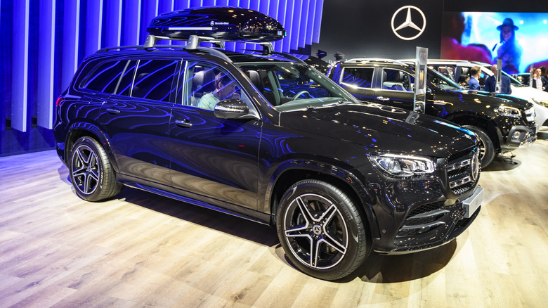 A shiny black Mercedes Benz GLC class on a showroom floor