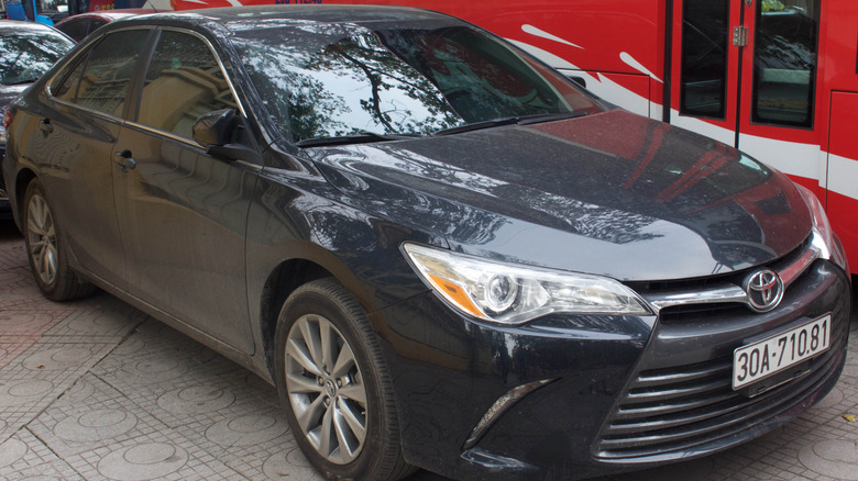 Dark blue 2015 Toyota Camry sitting in the street