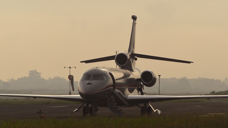 trijet plane runway sunset